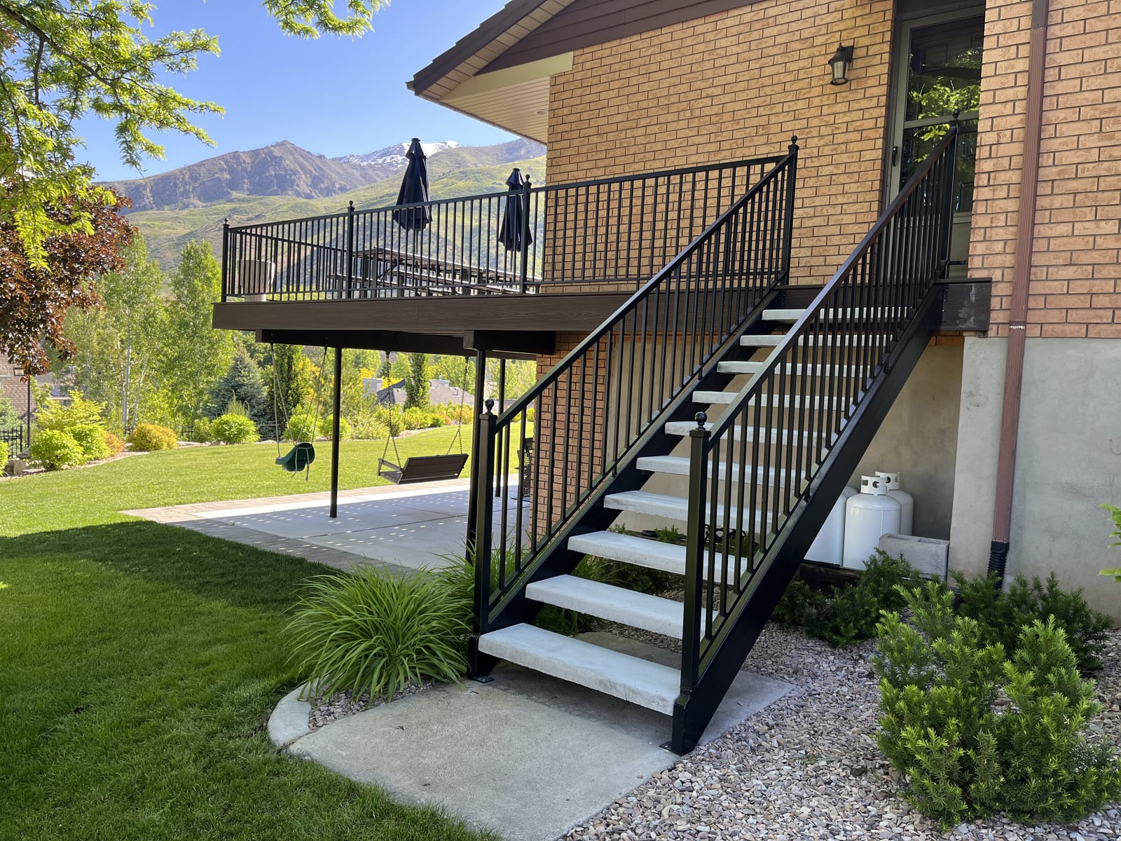 Elevated Trex deck with black railings and panoramic Utah mountain view